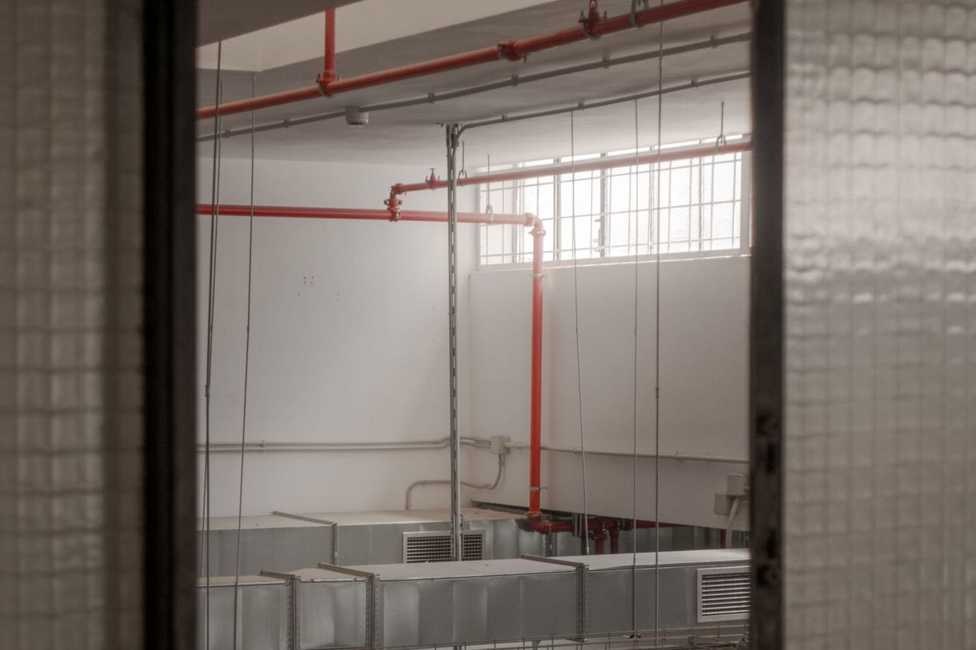 Vertical service pipes and ductwork inside an enclosed shaft